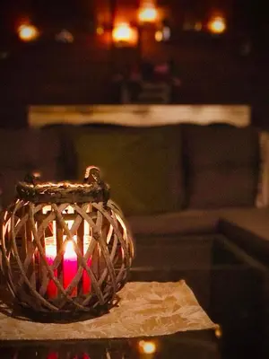 a candle in a wicker basket on a table at Modern 2BR city flat 10min from the beach in Athens