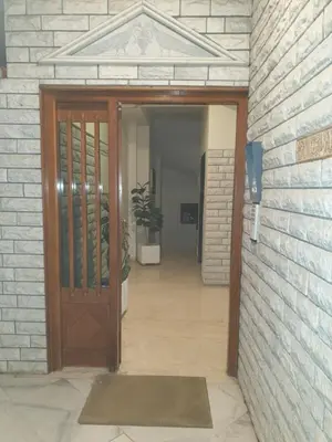 a door into a hallway with a potted plant at Modern 2BR city flat 10min from the beach in Athens