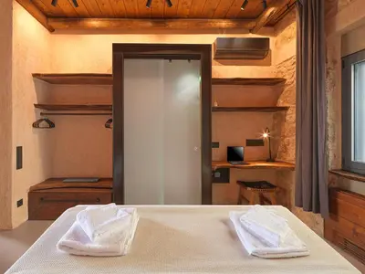 a bedroom with a bed with two white towels at Sea View Garden Suites in Piraeus