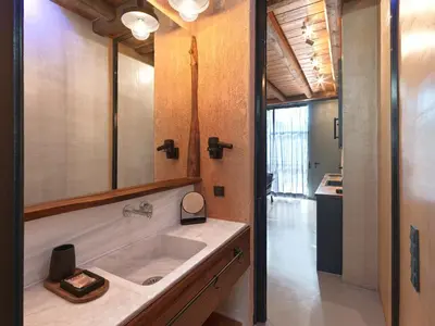 a bathroom with a sink and a mirror at Sea View Garden Suites in Piraeus