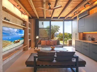 a living room with a couch and a large window at Sea View Garden Suites in Piraeus