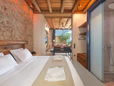 a bedroom with a bed and a bathroom with a shower at Sea View Garden Suites in Piraeus