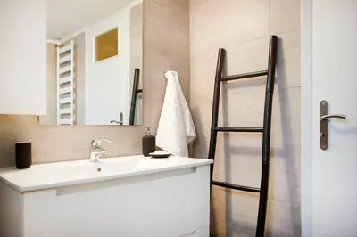 a bathroom with a sink and a mirror at Luxury Apartment with Exceptional View in Athens