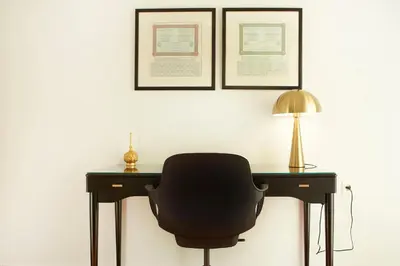 a black chair sitting at a desk with a lamp at Luxury Apartment with Exceptional View in Athens
