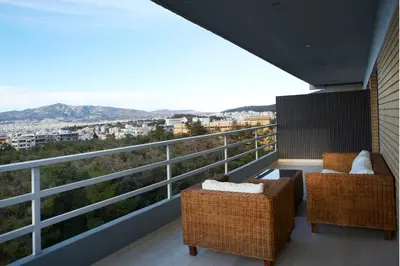 a balcony with two chairs and a view of the city at Luxury Apartment with Exceptional View in Athens