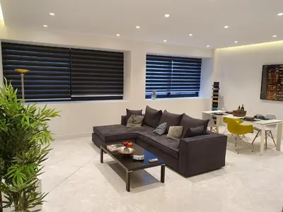 a living room with a couch and a table at Stylish Central Apartment in Kolonaki (walking distance to Syntagma) in Athens