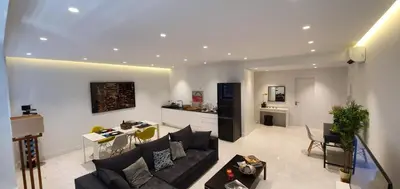a living room with a couch and a kitchen at Stylish Central Apartment in Kolonaki (walking distance to Syntagma) in Athens