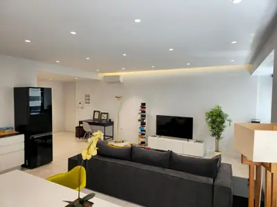 a living room with a couch and a flat screen tv at Stylish Central Apartment in Kolonaki (walking distance to Syntagma) in Athens