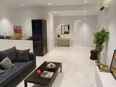 a living room with a couch and a table at Stylish Central Apartment in Kolonaki (walking distance to Syntagma) in Athens