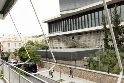 a building with people walking in front of it at Spacious High-Ceiling 2-Bedroom by Acropolis Museum in Athens
