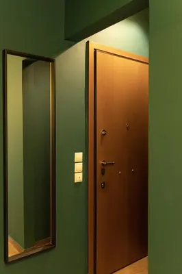 a hallway with a door and a mirror at Spacious High-Ceiling 2-Bedroom by Acropolis Museum in Athens
