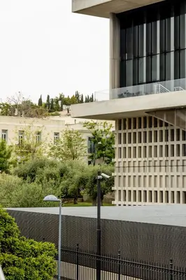 a building with a fence in front of it at Spacious High-Ceiling 2-Bedroom by Acropolis Museum in Athens