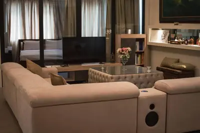 a living room with a couch and a television at Λabirinthia in Athens