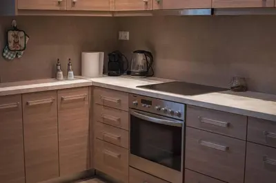 a kitchen with wooden cabinets and a stove top oven at Λabirinthia in Athens