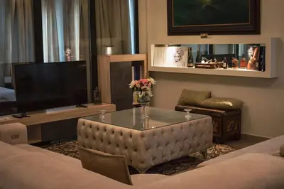 a living room with a couch and a tv at Λabirinthia in Athens