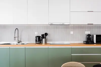 a kitchen counter with a sink and a microwave at The Gate by Zoia Living in Athens