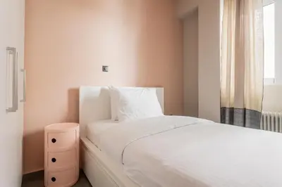a bedroom with a white bed and a window at The Gate by Zoia Living in Athens