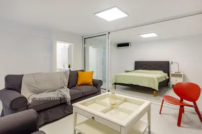 a living room with a couch and a table at Kookaki by Zoia Living in Athens