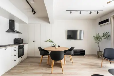 a kitchen and dining room with a table and chairs at Kookaki by Zoia Living in Athens