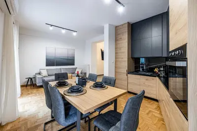 a dining room and living room with a table and chairs at Hi end Pagrati /2bdr apartment ! in Athens