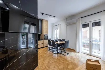 a kitchen and dining room with a table and chairs at Hi end Pagrati /2bdr apartment ! in Athens
