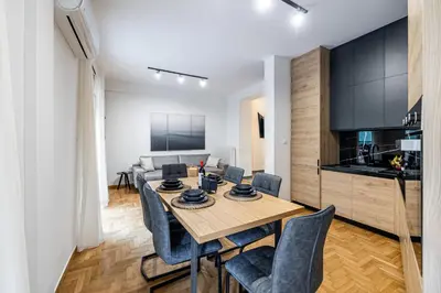 a dining room and living room with a table and chairs at Hi end Pagrati /2bdr apartment ! in Athens