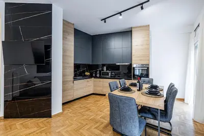 a kitchen and dining room with a table and chairs at Hi end Pagrati /2bdr apartment ! in Athens