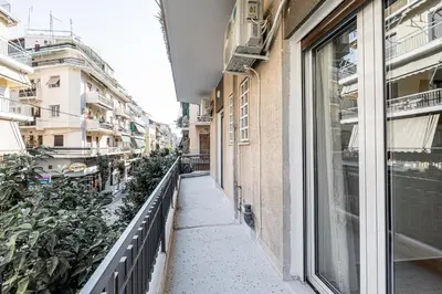 a corridor of a building with a window at Hi end Pagrati /2bdr apartment ! in Athens