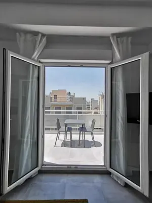 a balcony with a table and a view of a patio at Ikarus in Athens