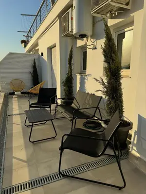 a patio with chairs and plants on a building at Ikarus in Athens