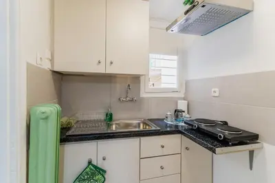 a small kitchen with a sink and a counter top at Green boho apartment in Athens