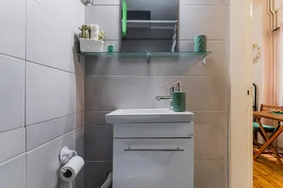 a bathroom with a sink and a toilet at Green boho apartment in Athens