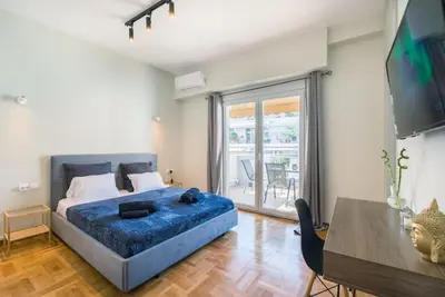 a bedroom with a bed and a table and a television at lecabetus penthouse in Athens