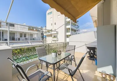 a patio with a table and chairs on a balcony at lecabetus penthouse in Athens