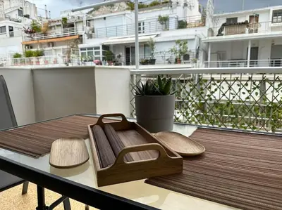 a wooden tray sitting on top of a table on a balcony at lecabetus penthouse in Athens