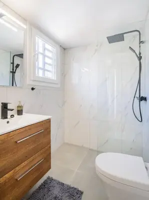 a bathroom with a shower and a toilet and a sink at lecabetus penthouse in Athens