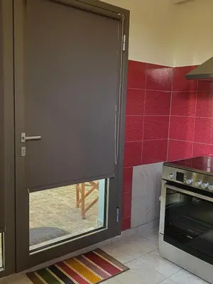 a door that is open in a kitchen at Helen's cozy studio (close to the airport) in Koropíon