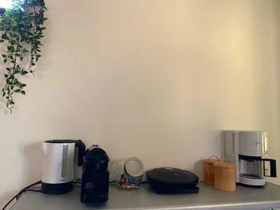 a counter top with two coffee makers on it at Helen's cozy studio (close to the airport) in Koropíon