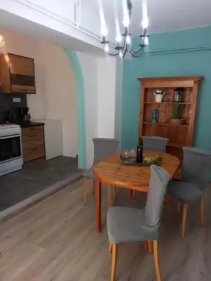 a dining room with a wooden table and chairs at Spata Lykourgos Homes in Spáta