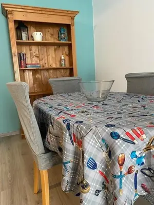 a table with a quilt on top of it with two chairs at Spata Lykourgos Homes in Spáta