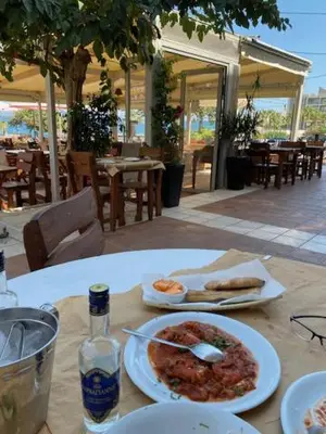 a table with a plate of food on a table at Spata Lykourgos Homes in Spáta
