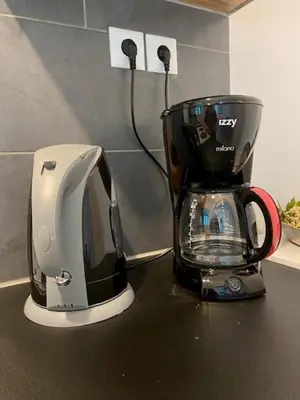 a coffee maker sitting on top of a counter at Spata Lykourgos Homes in Spáta