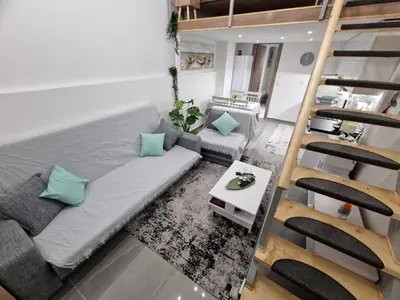 a living room with a couch and a staircase at Dimosthenis_Loft1 in Athens
