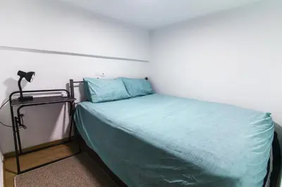 a bedroom with a bed with a green comforter at Dimosthenis_Loft1 in Athens