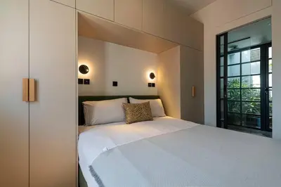 a bedroom with a large white bed and a window at Stylish Contemporary Penthouse - Hip Athens Centre in Athens
