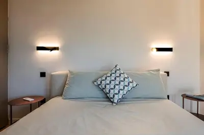 a bed with two pillows on it in a room at Stylish Contemporary Penthouse - Hip Athens Centre in Athens