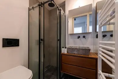 a bathroom with a shower and a toilet and a sink at Stylish Contemporary Penthouse - Hip Athens Centre in Athens