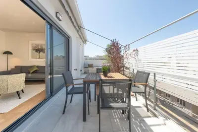a room with a table and chairs on a balcony at Stylish Contemporary Penthouse - Hip Athens Centre in Athens