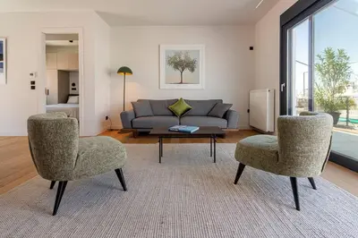 a living room with a couch and two chairs and a table at Stylish Contemporary Penthouse - Hip Athens Centre in Athens