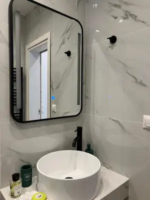 a white bathroom with a sink and a mirror at Mr Negri in Athens